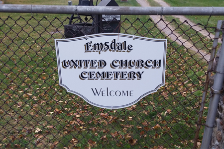 Cemetery with sign written Emsdale United Church cemetery